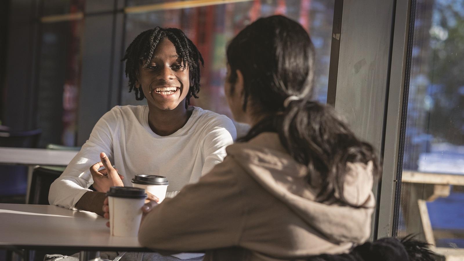 boy taking to a girl over coffee