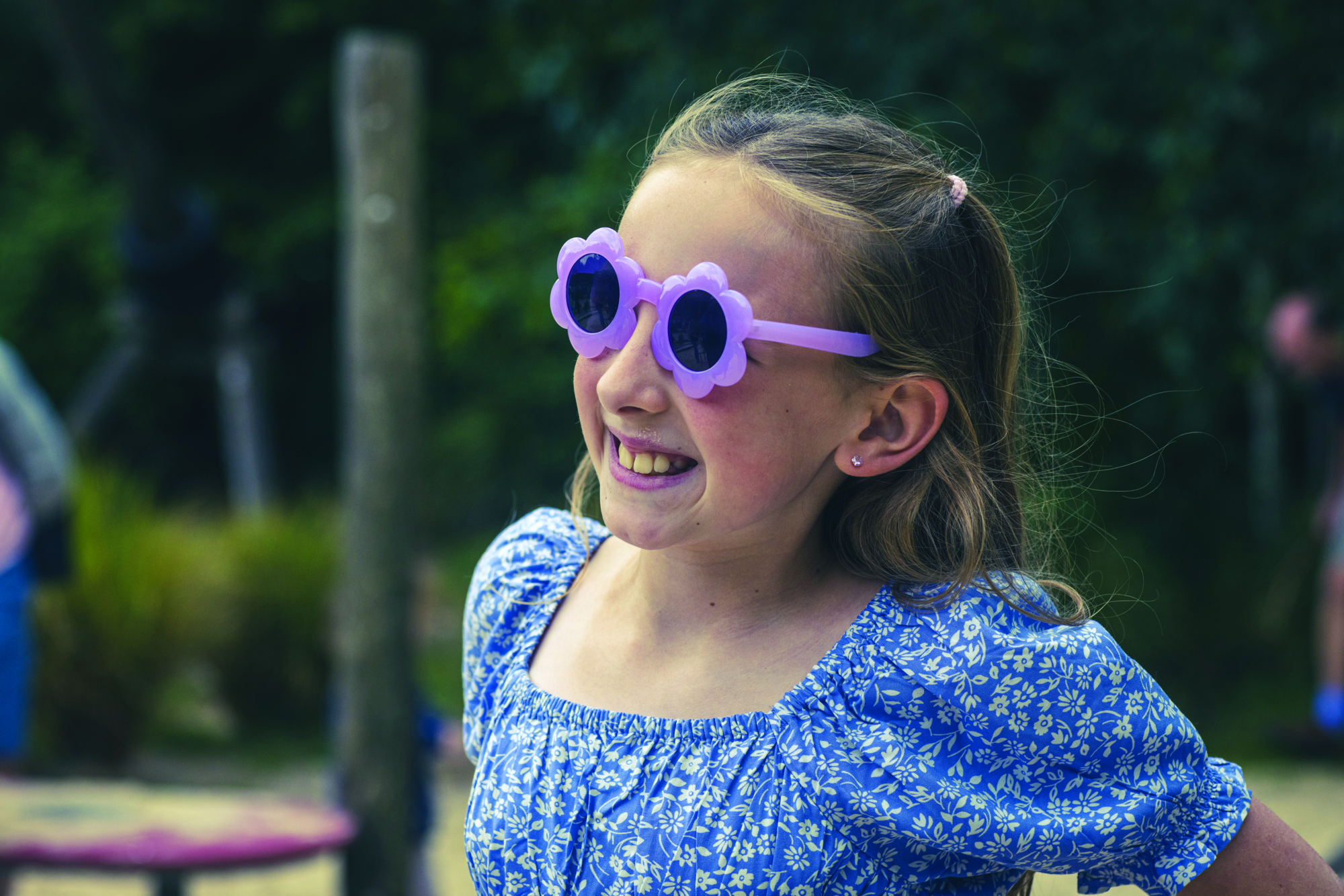 young girl with sun glasses smiling